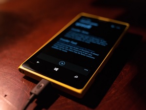 gold cellphone charging with text on the screen