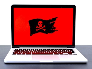 Open Laptop with a red background and a black flag with skull and crossbones