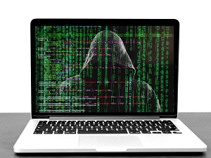 laptop with picture of a hacker and computer code