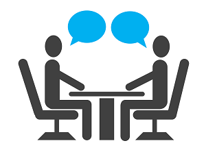 picture of two stick people sitting at a table talking
