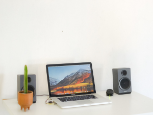 laptop on desk with speakers