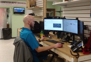 Computer Depot Business Solutions Technician working at a desk
